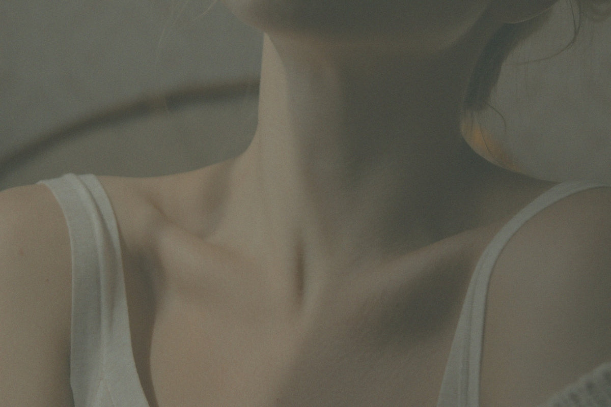 Edited photo of woman's collar bones, neck, and chin