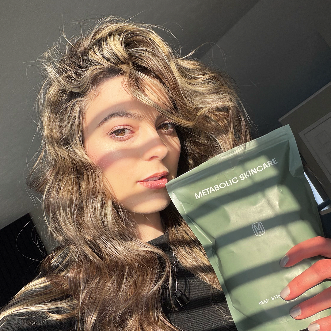 woman holding metabolic skincare package